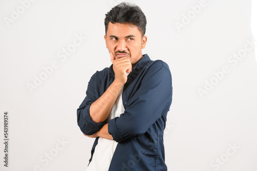 Portrait of Young asian man in blue shirt isolated on white background. Expression and lifestyle concept. © Johnstocker