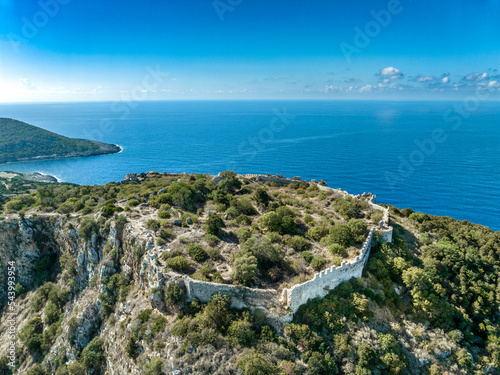 Ruins of the old Venetian fortress above the blue waters of Navarino beach in Greece photo