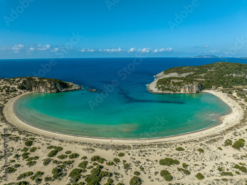 Aerial view of Voidokilia beach on the Navarino coast in Greece with turquoise water forming a crescent half moon bay popular vacation spot for German tourists