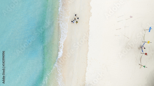 Natural Beach concept summer vacation. Nature of tropical summer beach. Umbrella board a boat and boat on the Sand Beach and Tourism Happy for playing on sand.