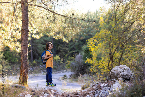 child is traveling. boy with a backpack on a hike.