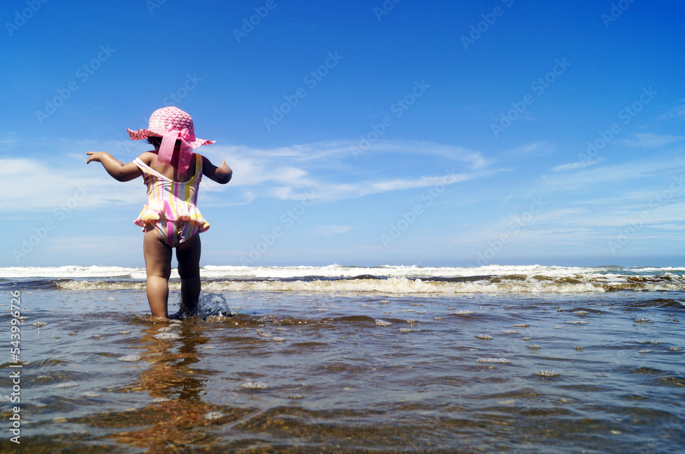 nena caminando en la playa
