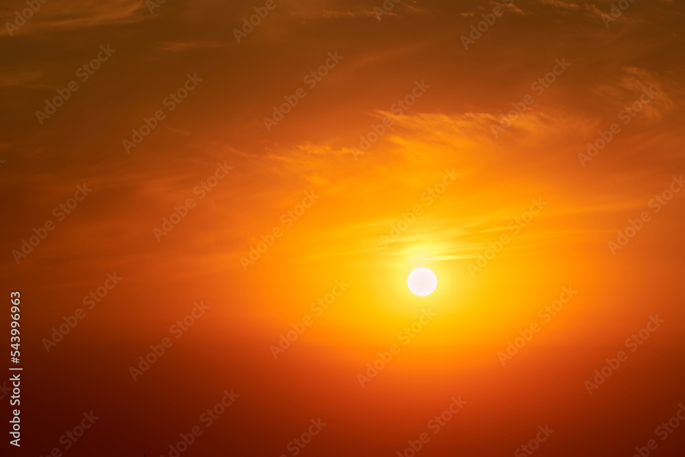 A big red sun in the sunset sky, a summer landscape. Evening sky in hot sunlight A big red sun in the sunset sky, a summer landscape. Evening sky in hot sunlight