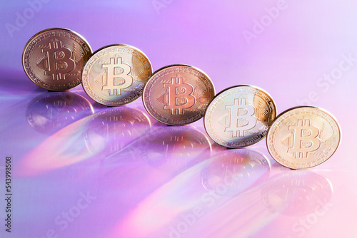 Golden bitcoin coins on holographic, abstract, neon background. digital currency, business style. Mining and trade bitcoin concept. selective focus photo