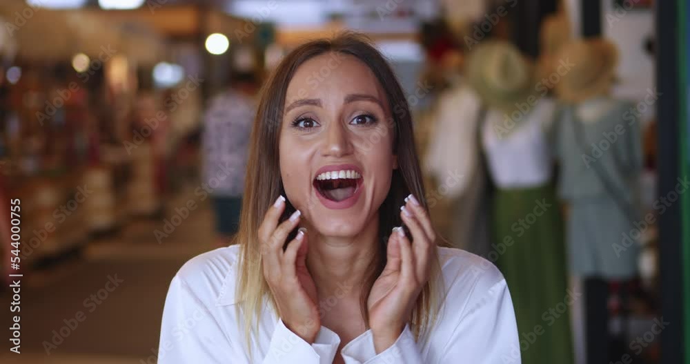 Main focus on positive emotions of an attractive young brunette woman experiencing happiness and stupefaction from good news, laughing and smiling a cheerful toothy smile looking at the camera Main focus on positive emotions of an attractive young brunette woman experiencing happiness and stupefaction from good news, laughing and smiling a cheerful toothy smile looking at the camera