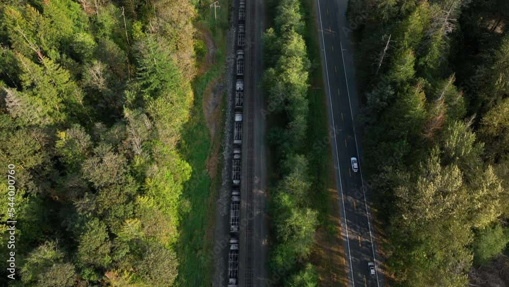 Top down aerial view of a train racing cars on the highway. Top down aerial view of a train racing cars on the highway.
