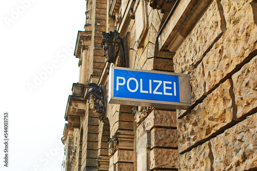Police station sign on the wall of a building in Germany
