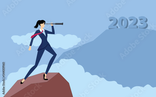 Businesswoman holding telescope on top of a mountain