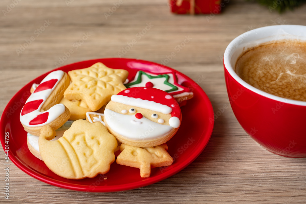 Merry Christmas with homemade cookies and coffee cup on wood table background. Xmas eve, party, holiday and happy New Year concept Merry Christmas with homemade cookies and coffee cup on wood table background. Xmas eve, party, holiday and happy New Year concept