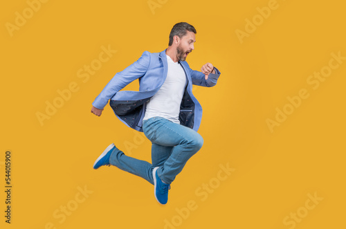 Businessman hurry being late. Shocked late businessman checking time in midair. late businessman