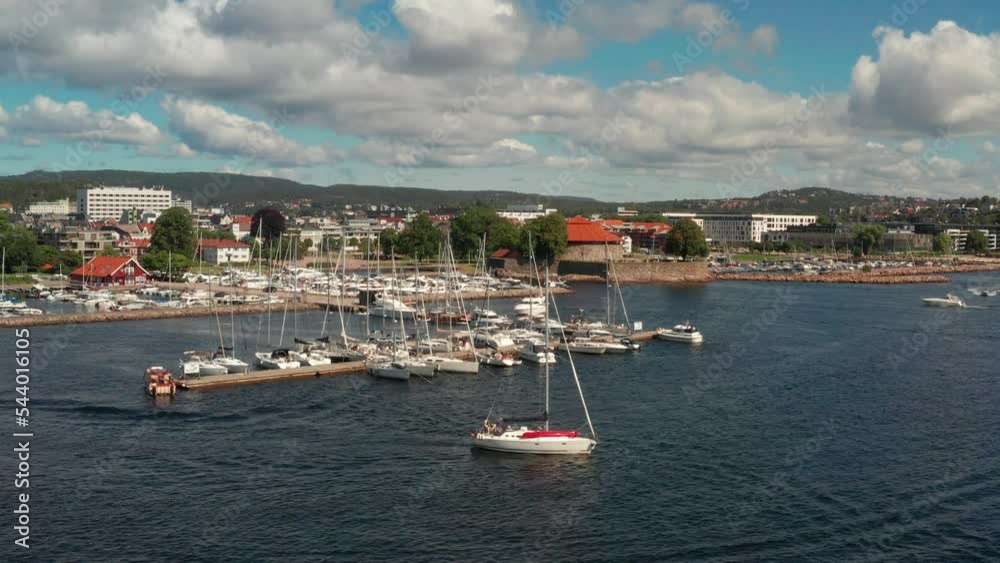 Sailboat leaving harbour of kristiansand in Norway Sailboat leaving harbour of kristiansand in Norway