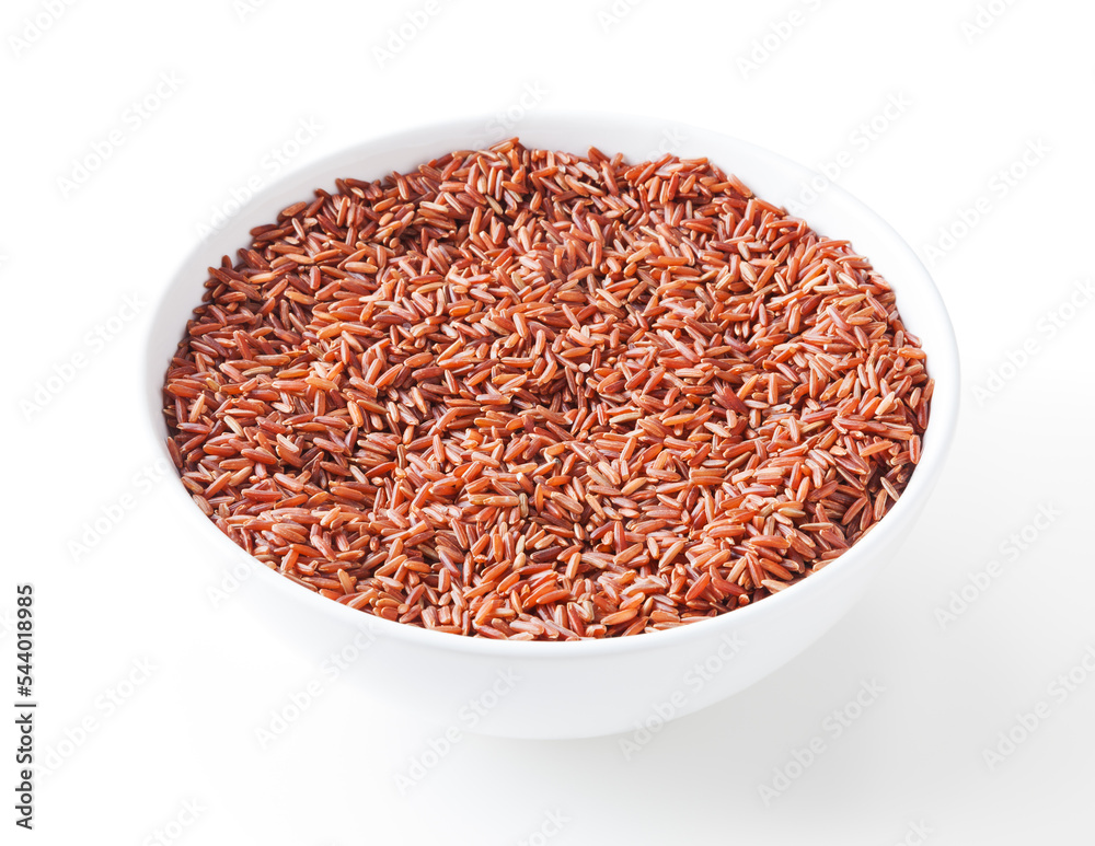 Uncooked red rice in white bowl isolated on white background with clipping path