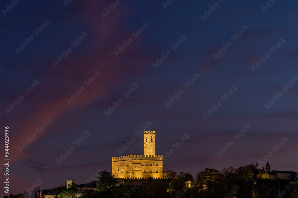 The historic center of Poppi, Arezzo, Italy, dominated by the Conti Guidi castle in the twilight light