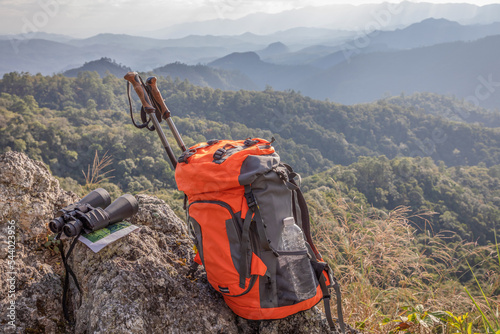 binoculars and map and backpack on the rock mountains.