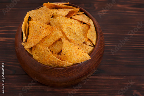 Tortilla chips on wooden background.
Mexican Nachos Chips in a wooden bowl on wooden background from above, with copy space for text.
