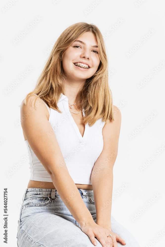 Smiling teenage girl with blond hair in studio Smiling teenage girl with blond hair in studio
