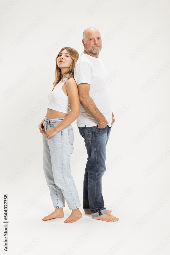 Confident father and daughter with hands in pockets at studio Confident father and daughter with hands in pockets at studio