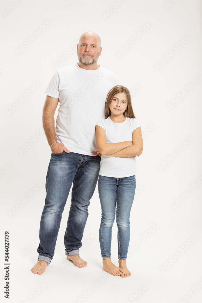 Confident father and daughter against white background Confident father and daughter against white background