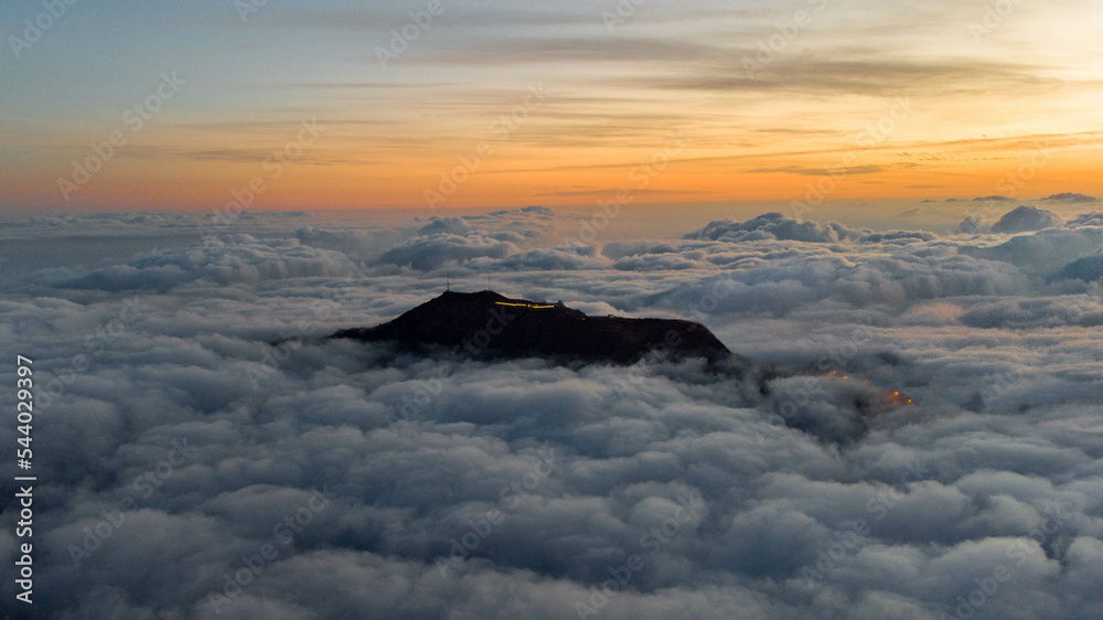 mountain over the clouds at sunset