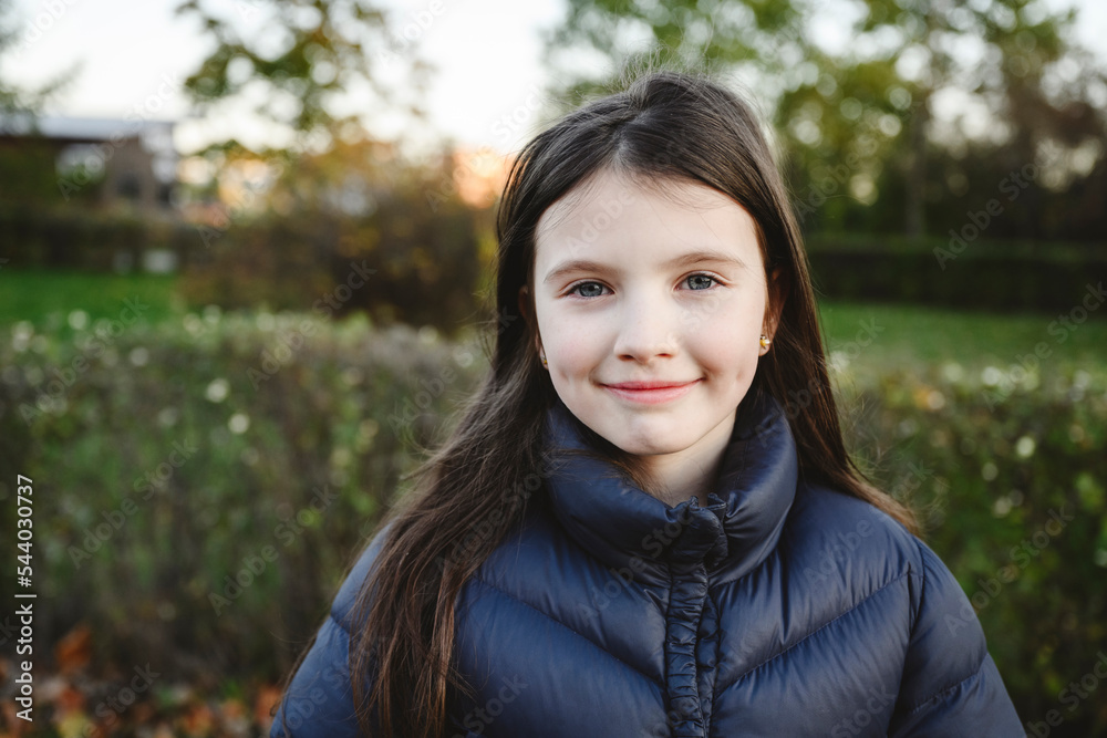 Smiling girl with long hair wearing padded jacket Smiling girl with long hair wearing padded jacket