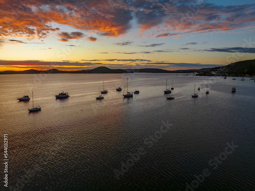 Aerial sunrise over the bay with boats and clouds