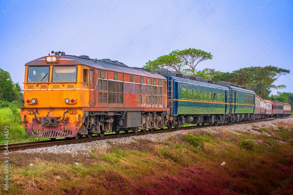 Passenger train by diesel locomotive on the railway.