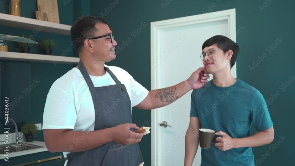 Young Asian gay LGBTQ cooking breakfast in kitchen hand hold morning coffee, Homosexual in love newlywed happy eat sandwich bread and coffee, two cheerful men serves breakfast to each other with love
Young Asian gay LGBTQ cooking breakfast in kitchen hand hold morning coffee, Homosexual in love newlywed happy eat sandwich bread and coffee, two cheerful men serves breakfast to each other with love