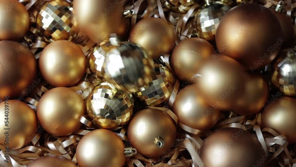 christmas background - close up of falling golden Christmas baubles in slow motion christmas background - close up of falling golden Christmas baubles in slow motion