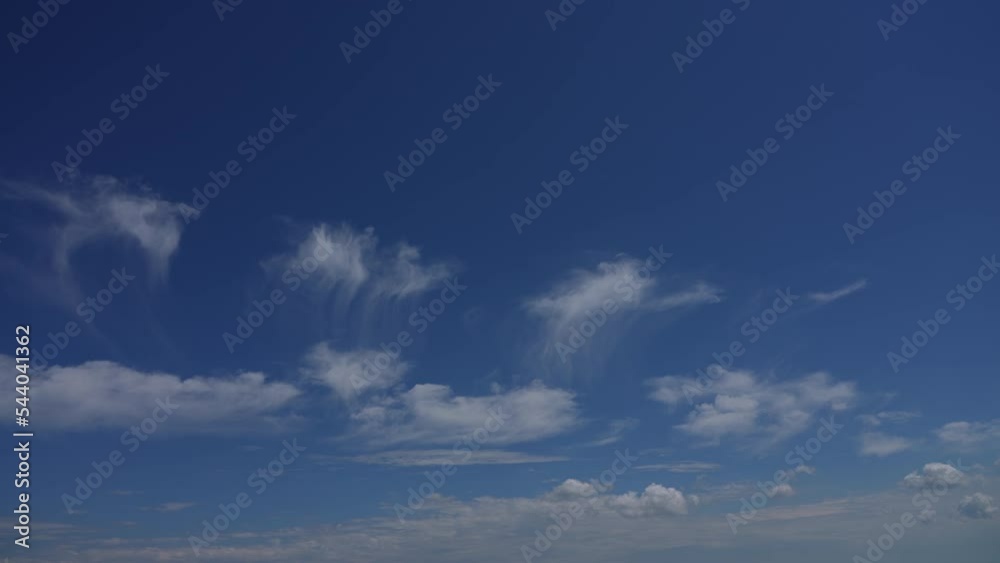 Beautiful clear blue sky with white fluffy clouds. 4k stock video time lapse of amazing peaceful sunny cloudscape. White soft small clouds flying slowly high in sunny blue heaven. Natural background Beautiful clear blue sky with white fluffy clouds. 4k stock video time lapse of amazing peaceful sunny cloudscape. White soft small clouds flying slowly high in sunny blue heaven. Natural background