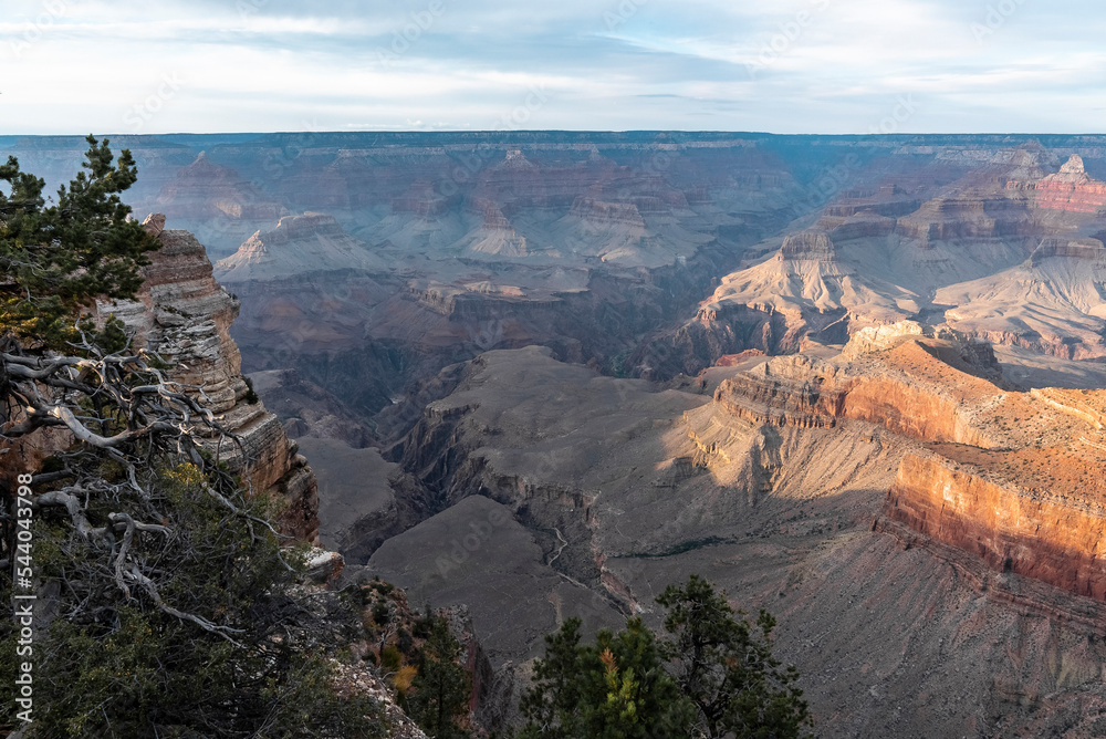 Scenic View Of Majestic Rocky Landscape With Horizon Against Cloudy Sky At Grand Canyon National Park In Arizona