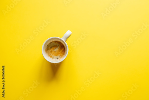 Fotobehang simple minimalism image of a cup of coffee on a yellow background