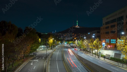 Itaewon Night Time Lapse of Car Light Trails in Noksapyeong-daero Road, View of N Seoul Namsan Tower Illuminated photo