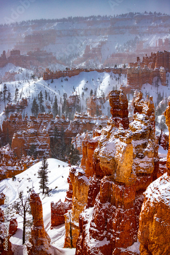 winter landscape of bryce canyon national park  freezing cold red rocks covered with snow  winter in the usa  landscape of mountains covered with snow  winter in the state of utah