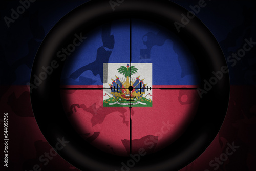 sniper scope aimed at flag of haiti on the khaki texture background. military concept. 3d illustration photo