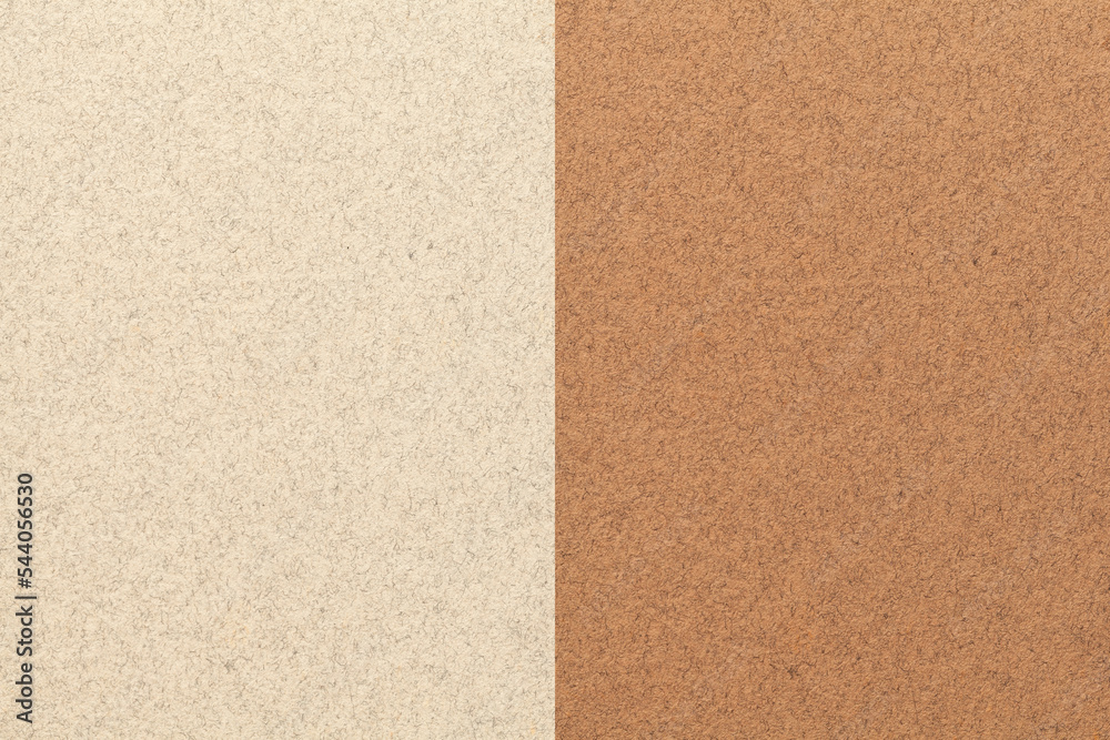 Fototapeta premium Texture of craft light beige and brown paper background, half two colors. Structure of vintage umber cardboard.