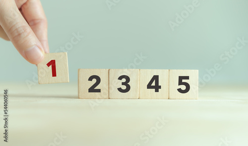 Task priority and management concept. The order of priority in any activity. Set work priority, arrange to do list. Wooden cubes with number first, second, third, fourth and fifth.