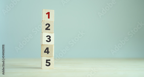 Task priority and management concept. The order of priority in any activity. Set work priority, arrange to do list. Wooden cubes with number first, second, third, fourth and fifth. photo