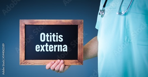 Otitis externa (swimmer's ear). Doctor shows sign/board with wooden frame. Background blue photo