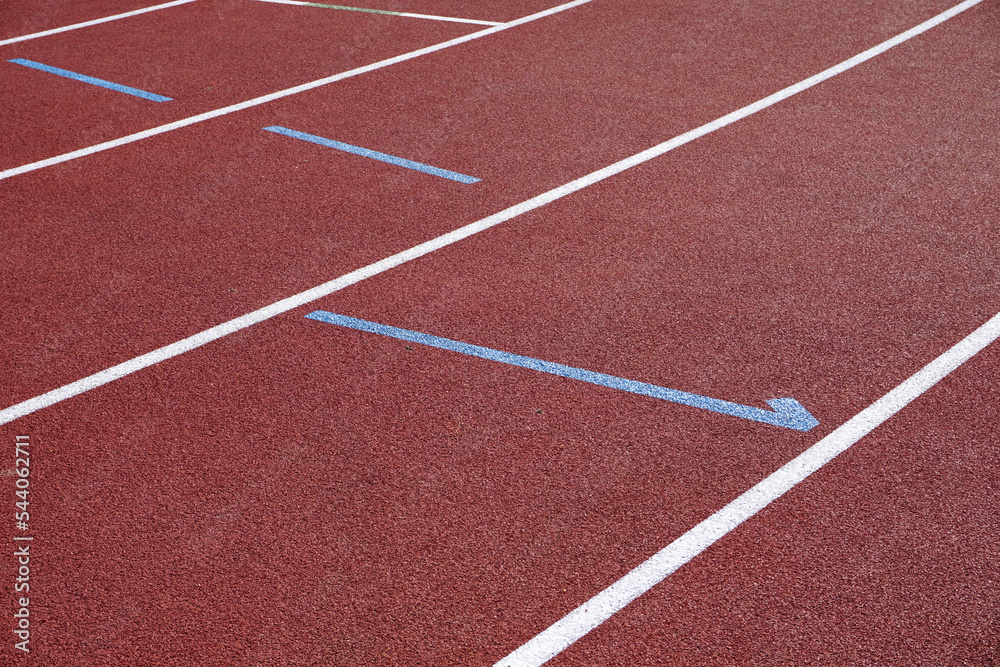 sports track running surface background. rubber ground of athletics track with painted lane markings