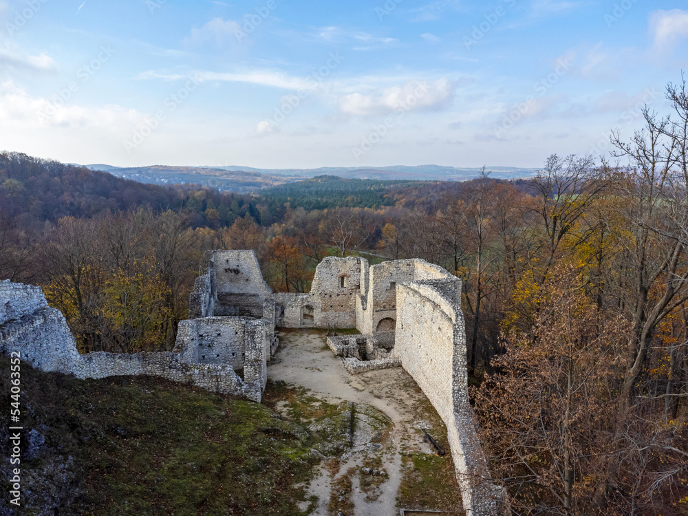 The castle ruins as seen from above. Aerial view. Castle, walls, historical, in forest, trees nature. Photo from a drone.