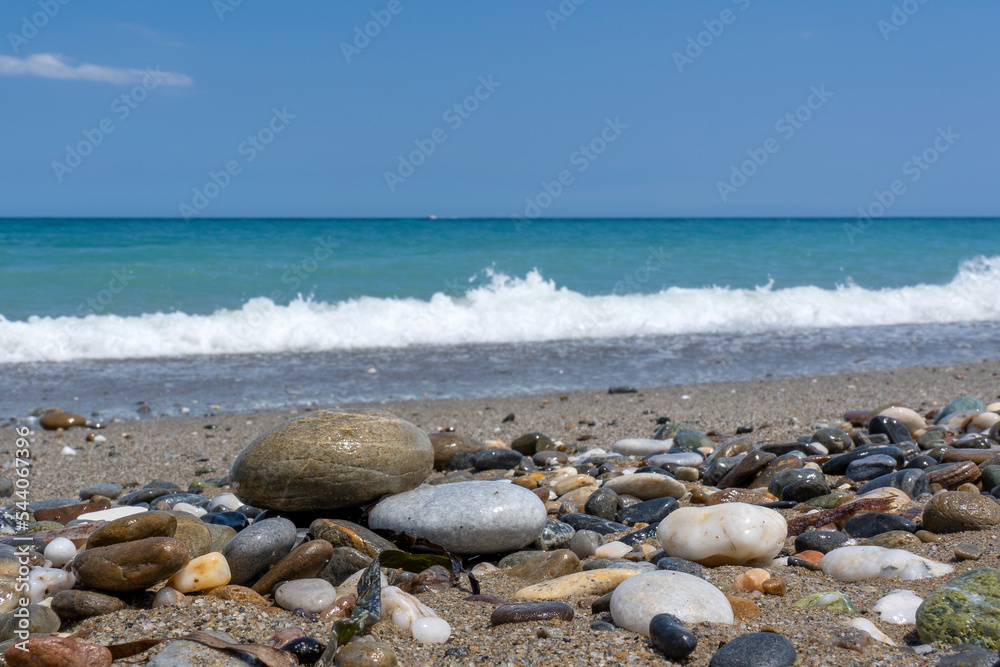 Big colorful and shiny stones on the high tide line of Missiria beach near Rethymno, Crete, Greece