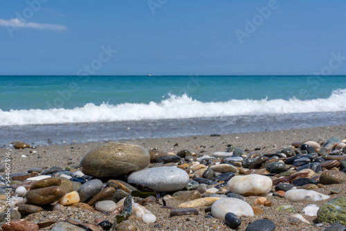 Big colorful and shiny stones on the high tide line of Missiria beach near Rethymno, Crete, Greece