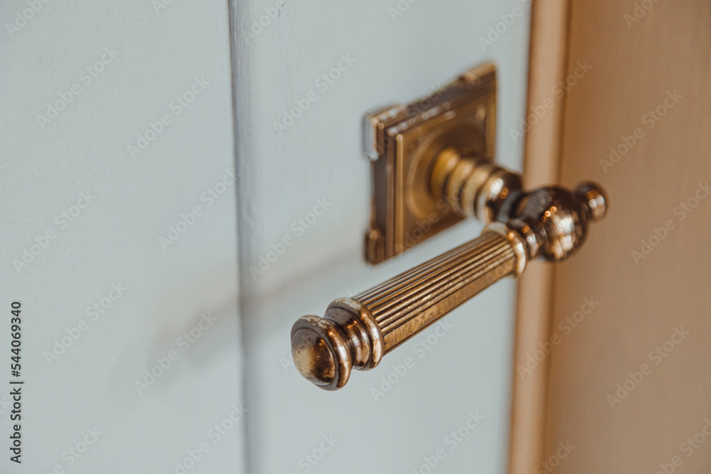 Bronze door handle in a classic style on a wooden interior door Bronze door handle in a classic style on a wooden interior door