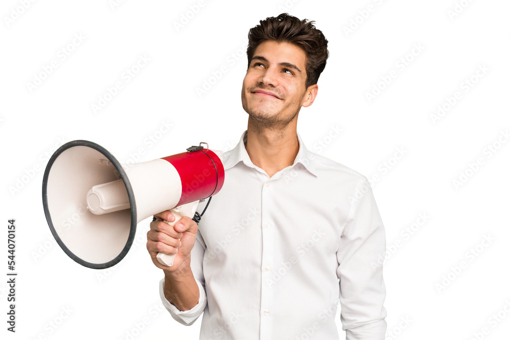 Young caucasian man holding megaphone isolated dreaming of achieving goals and purposes Young caucasian man holding megaphone isolated dreaming of achieving goals and purposes