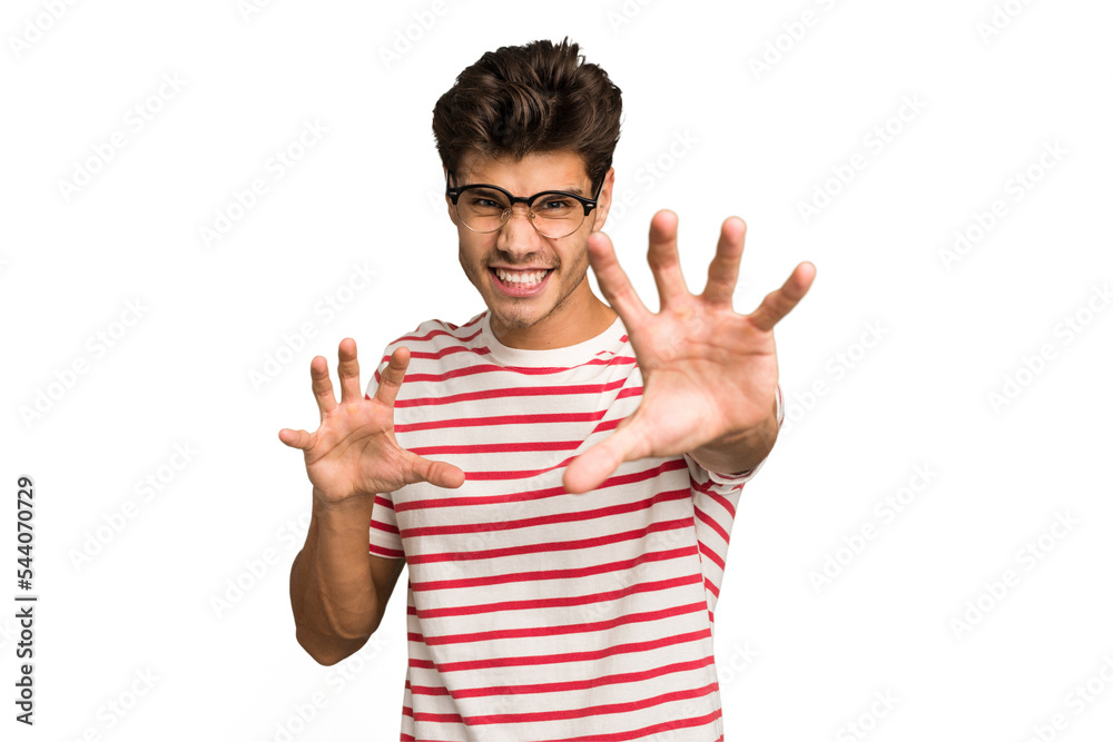 Young caucasian handsome man isolated showing claws imitating a cat, aggressive gesture. Young caucasian handsome man isolated showing claws imitating a cat, aggressive gesture.