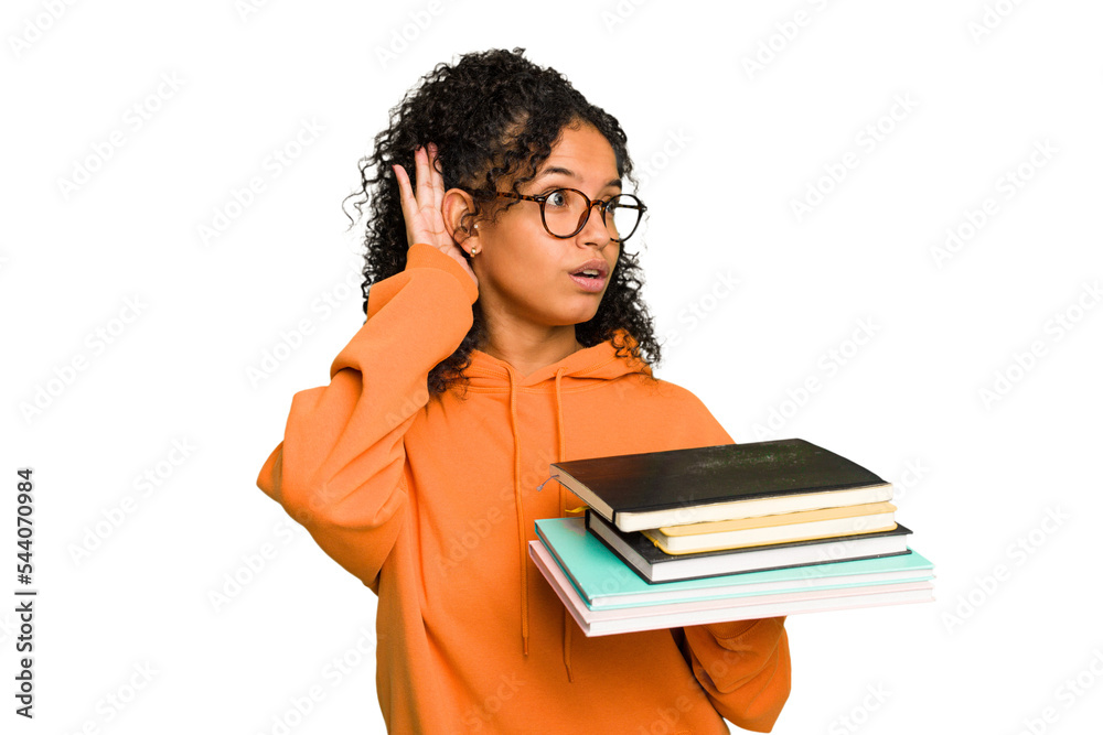 Young student woman holding a pile of books isolated trying to listening a gossip. Young student woman holding a pile of books isolated trying to listening a gossip.
