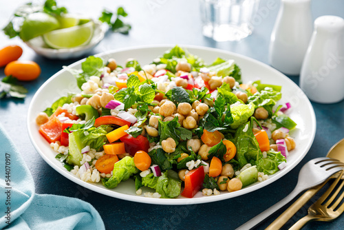 Tabbouleh salad. Tabouli salad with fresh parsley, onions, tomatoes, bulgur and chickpea. Healthy vegetarian food, diet