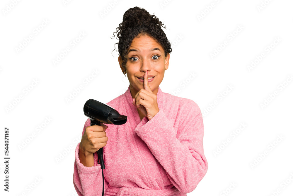 Young brazilian woman wearing a pink bathrobe holding an hairdryer isolated keeping a secret or asking for silence. Young brazilian woman wearing a pink bathrobe holding an hairdryer isolated keeping a secret or asking for silence.