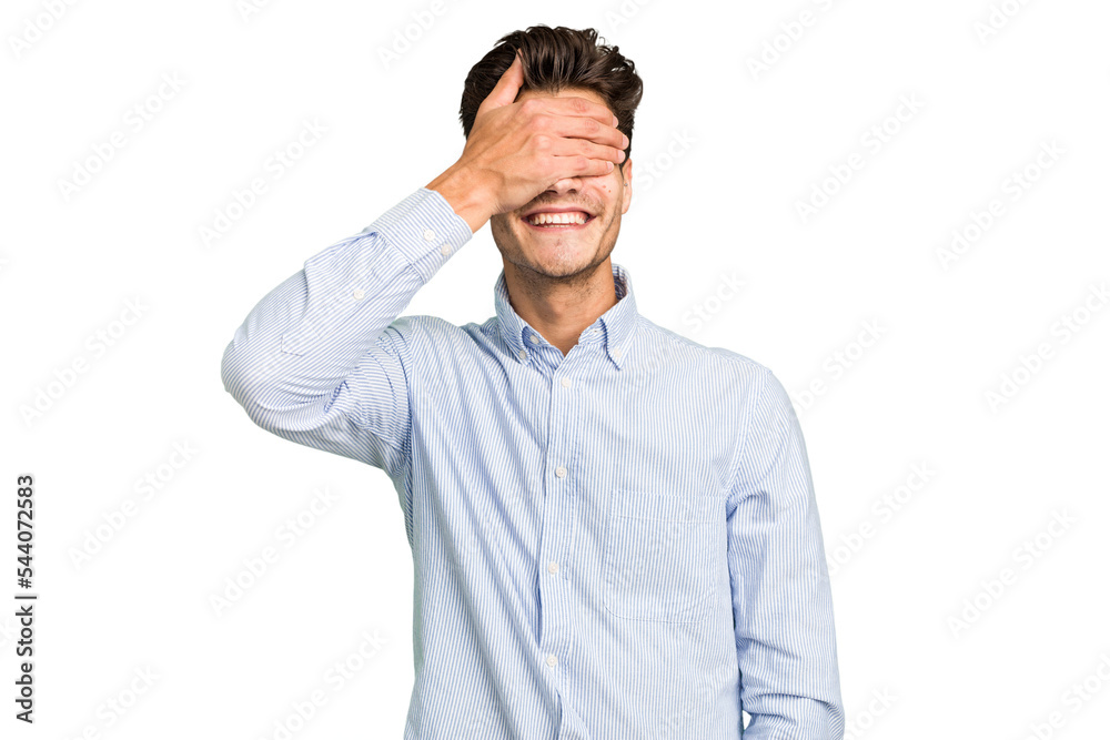 Young caucasian handsome man isolated covers eyes with hands, smiles broadly waiting for a surprise. Young caucasian handsome man isolated covers eyes with hands, smiles broadly waiting for a surprise.