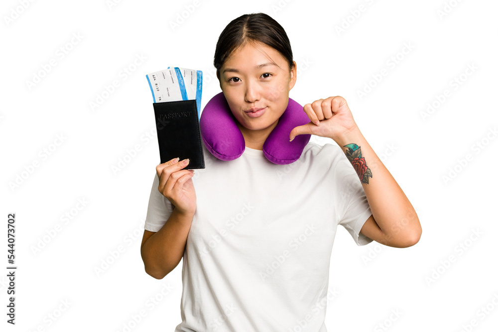 Young asian woman with inflatable travel pillow on her neck holding passport isolated feels proud and self confident, example to follow. Young asian woman with inflatable travel pillow on her neck holding passport isolated feels proud and self confident, example to follow.